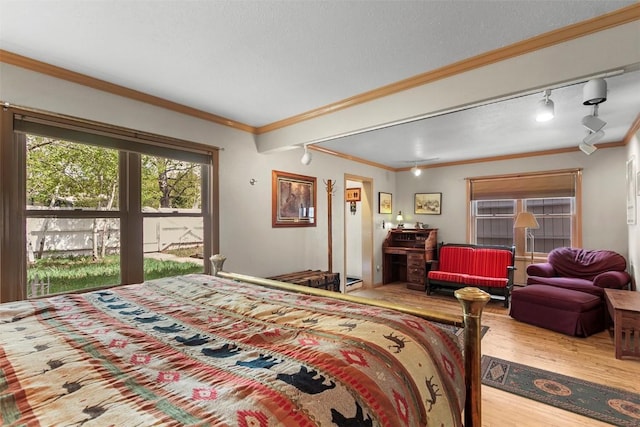 bedroom with crown molding and wood-type flooring