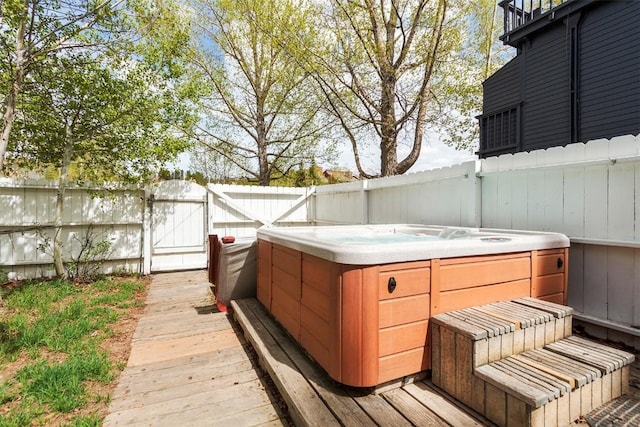 wooden deck featuring a hot tub