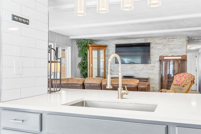 kitchen featuring open floor plan, light countertops, and a sink