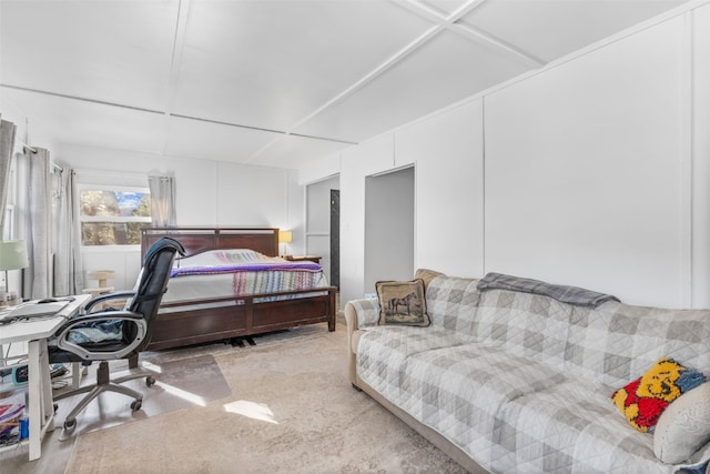 bedroom featuring light colored carpet and a decorative wall