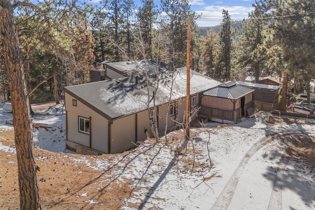 view of side of property with a shingled roof