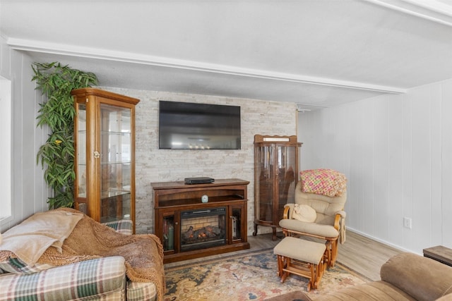 living area with a fireplace and wood finished floors