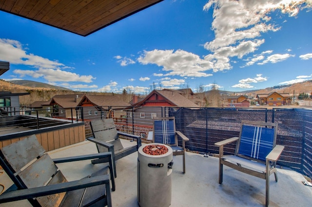 balcony featuring a mountain view and a fire pit