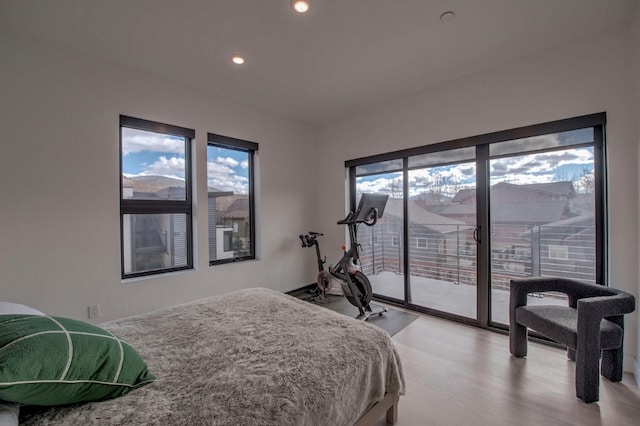 bedroom with access to exterior and light hardwood / wood-style flooring