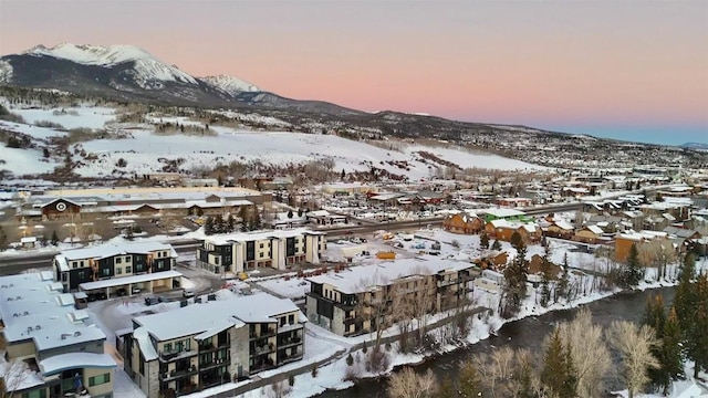 snowy aerial view with a mountain view