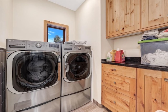 laundry room with cabinets and washer and clothes dryer