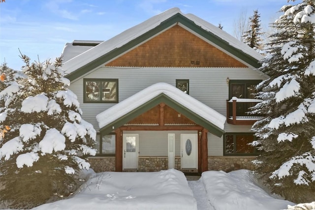 view of snow covered back of property