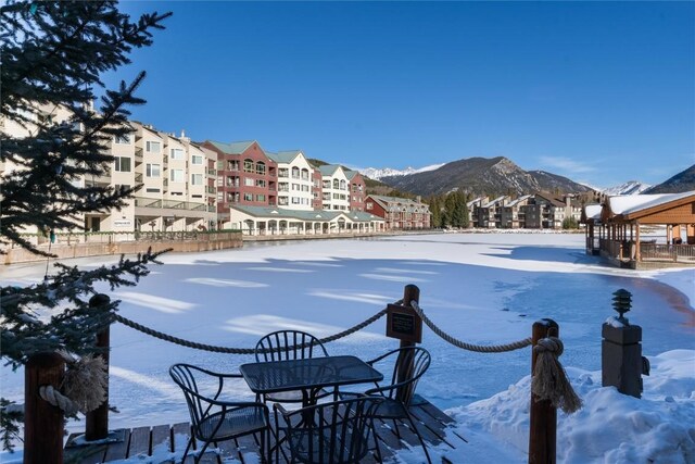 snow covered pool featuring a mountain view