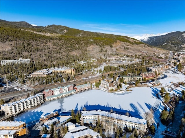 snowy aerial view with a mountain view