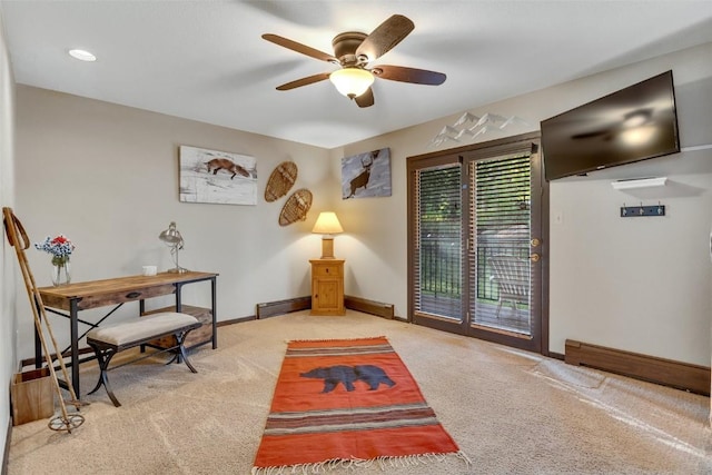 sitting room featuring light colored carpet, ceiling fan, and a baseboard heating unit