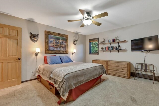 bedroom with ceiling fan and light colored carpet