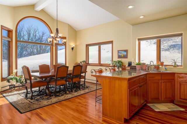 kitchen featuring pendant lighting, sink, a breakfast bar, stainless steel appliances, and a center island