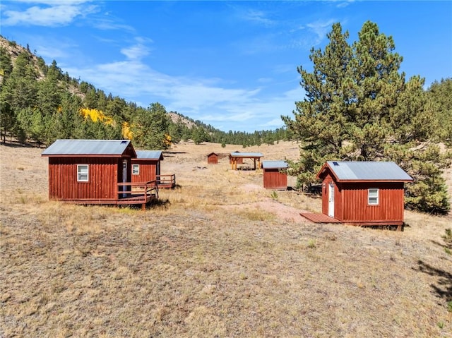 view of yard featuring a rural view and a storage unit