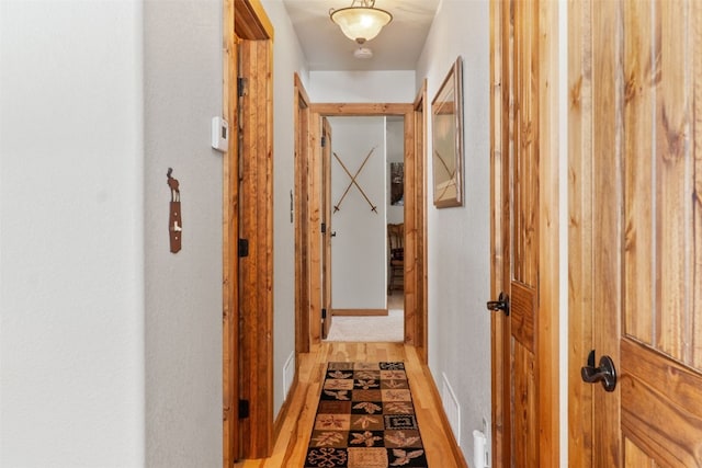 hall featuring light wood finished floors and visible vents