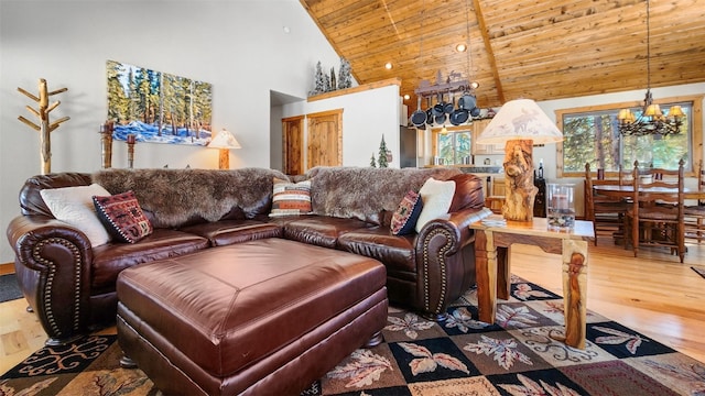 living area featuring high vaulted ceiling, wooden ceiling, wood finished floors, and an inviting chandelier