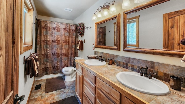 full bath featuring visible vents, a sink, and toilet