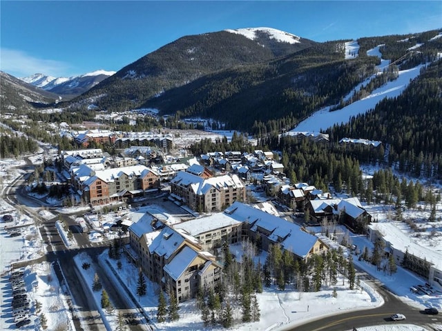 snowy aerial view with a mountain view