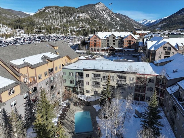 snowy aerial view with a mountain view