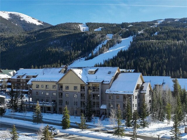 snowy aerial view with a mountain view