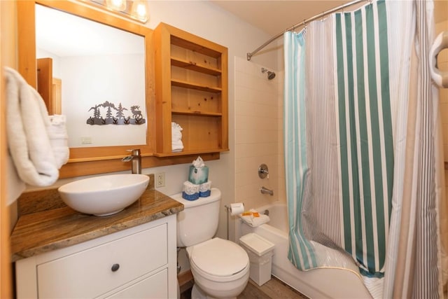 full bathroom featuring built in shelves, vanity, shower / tub combo with curtain, hardwood / wood-style floors, and toilet