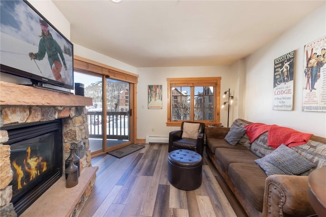 living room featuring a fireplace, dark hardwood / wood-style floors, and a baseboard heating unit