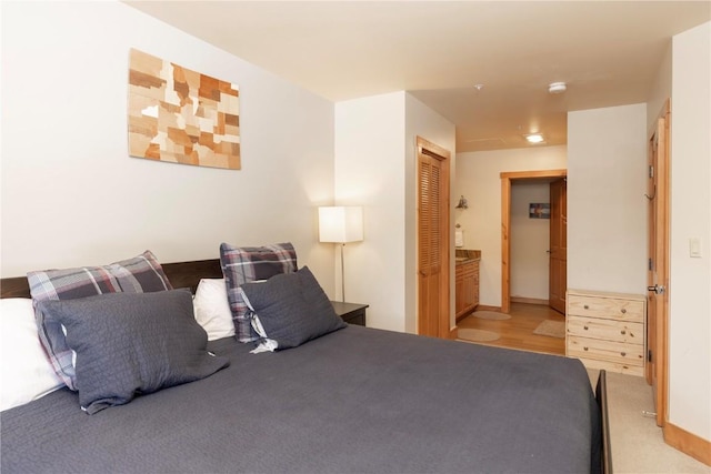 bedroom featuring ensuite bath and a closet