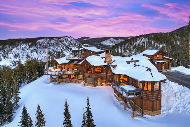 exterior space featuring a wooded view and a mountain view