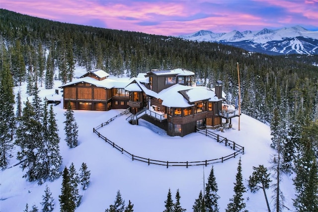 snowy aerial view featuring a mountain view