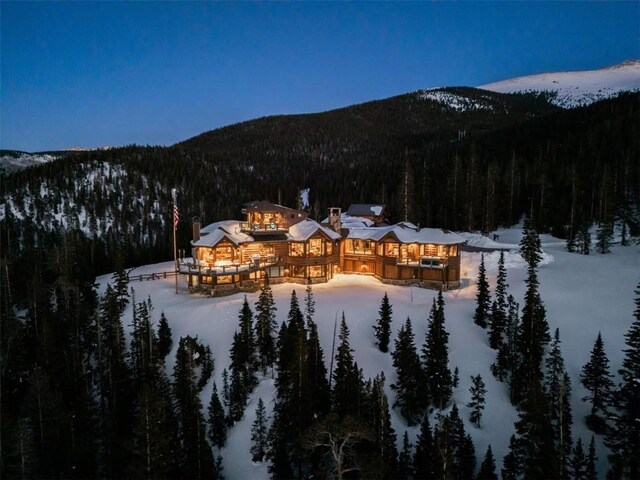 snowy aerial view featuring a mountain view