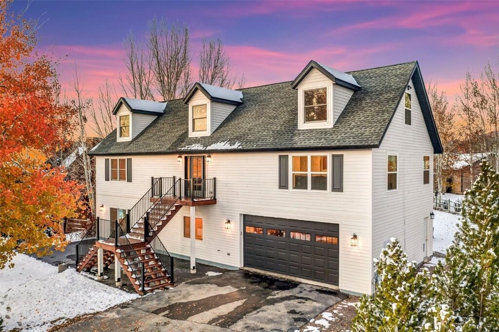 cape cod-style house featuring a garage