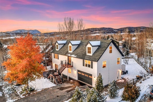 view of front facade featuring a mountain view and a garage