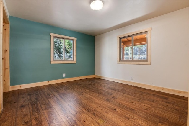 spare room featuring wood-type flooring and a healthy amount of sunlight