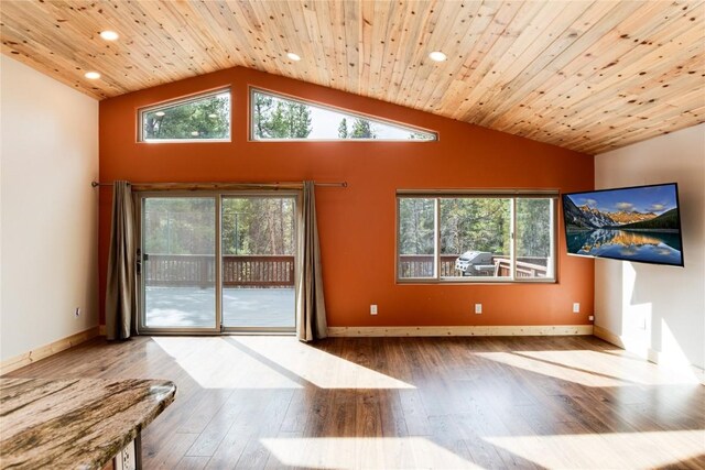 unfurnished living room featuring hardwood / wood-style floors, high vaulted ceiling, and wood ceiling