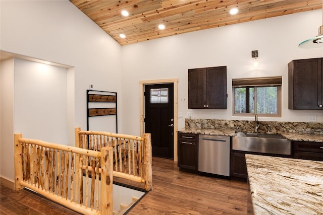 kitchen with hardwood / wood-style floors, high vaulted ceiling, sink, stainless steel dishwasher, and dark brown cabinets