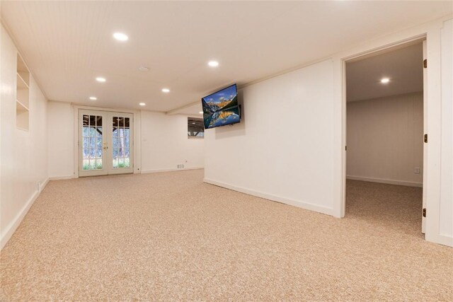 carpeted empty room featuring french doors