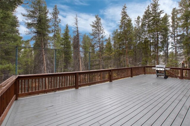 wooden terrace featuring a grill