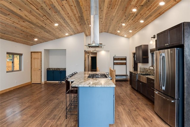 kitchen featuring a center island, light hardwood / wood-style floors, a breakfast bar area, wood ceiling, and appliances with stainless steel finishes