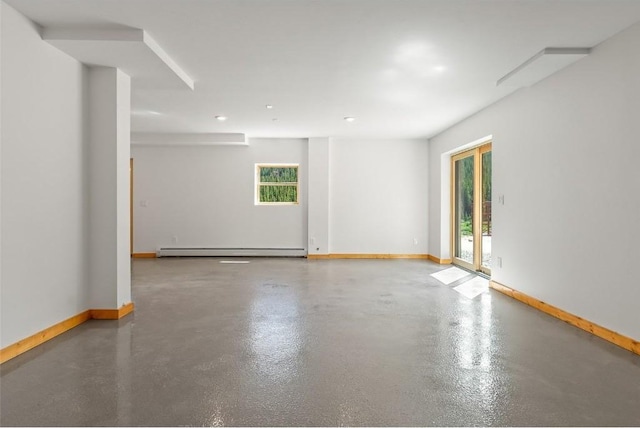 spare room with concrete floors and a baseboard heating unit