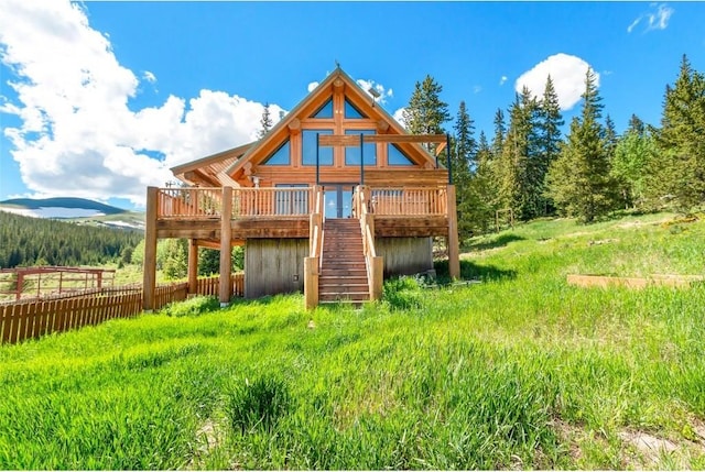 back of property with a deck with mountain view