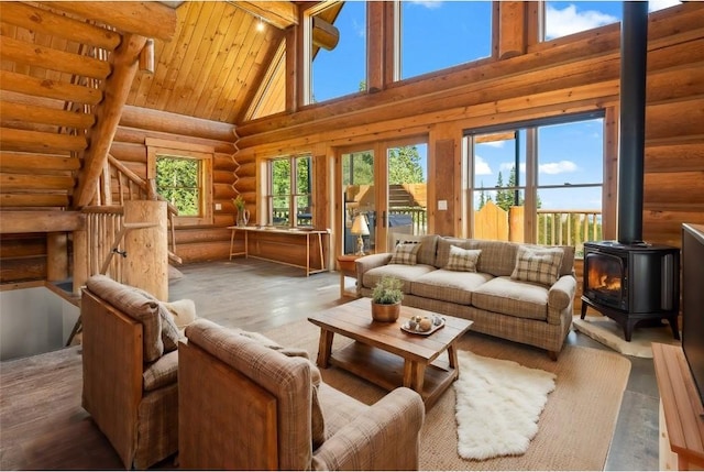 living room featuring a wood stove, wooden ceiling, high vaulted ceiling, rustic walls, and beam ceiling