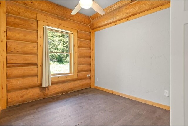 unfurnished room featuring wood-type flooring, rustic walls, and ceiling fan