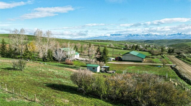 birds eye view of property with a mountain view and a rural view