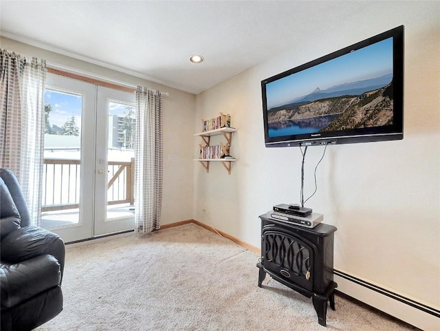 living area featuring carpet floors, a baseboard radiator, and french doors