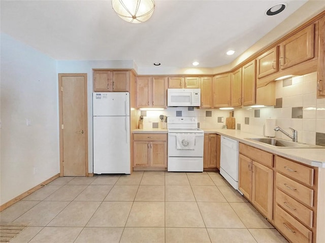 kitchen featuring sink, light tile patterned flooring, white appliances, and light brown cabinets