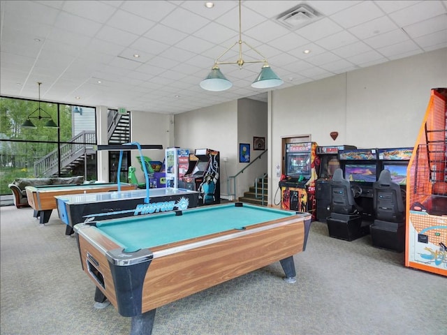 playroom featuring a paneled ceiling, light carpet, a wood stove, and pool table