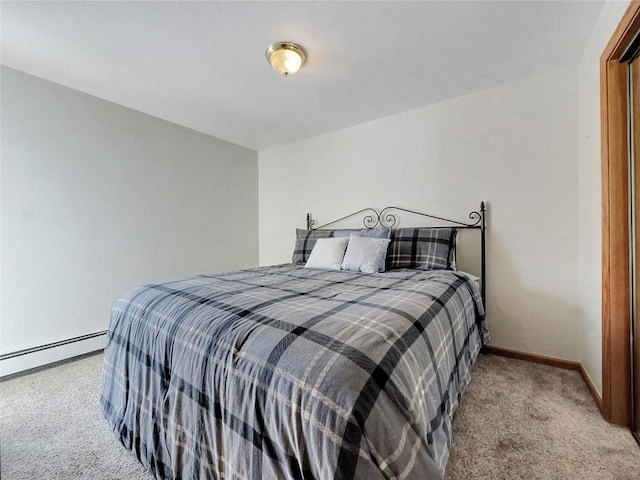 carpeted bedroom featuring baseboard heating