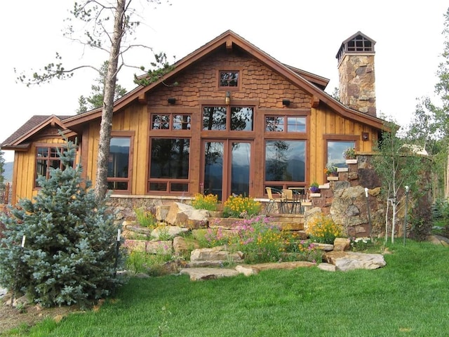 rear view of house featuring a lawn