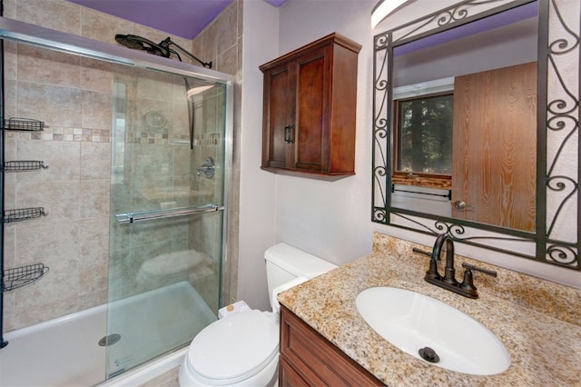 full bath with a shower stall, toilet, and vanity