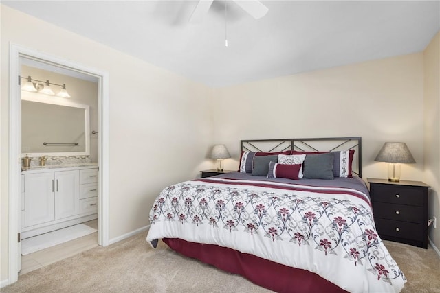 carpeted bedroom featuring sink, ensuite bath, and ceiling fan