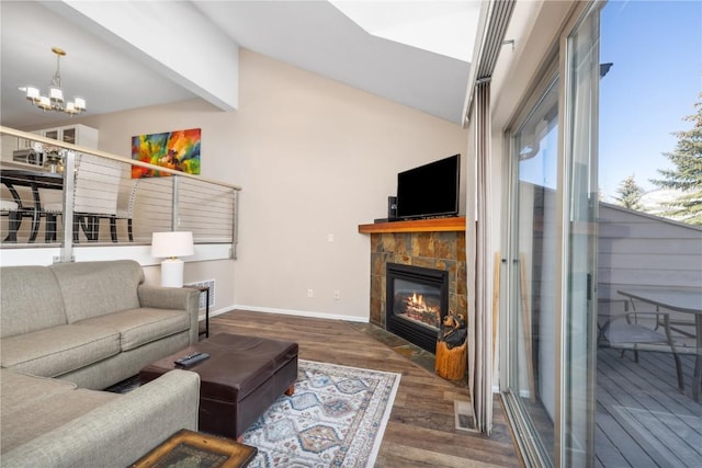 living room featuring a tile fireplace, vaulted ceiling with beams, dark wood-type flooring, and a notable chandelier